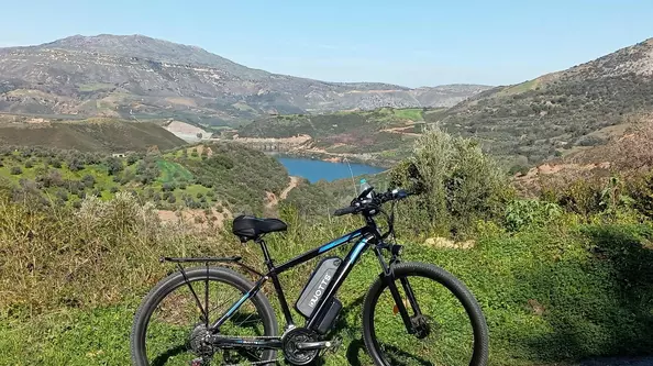 A Duotts C29 electric bike with mountains and a river in the background